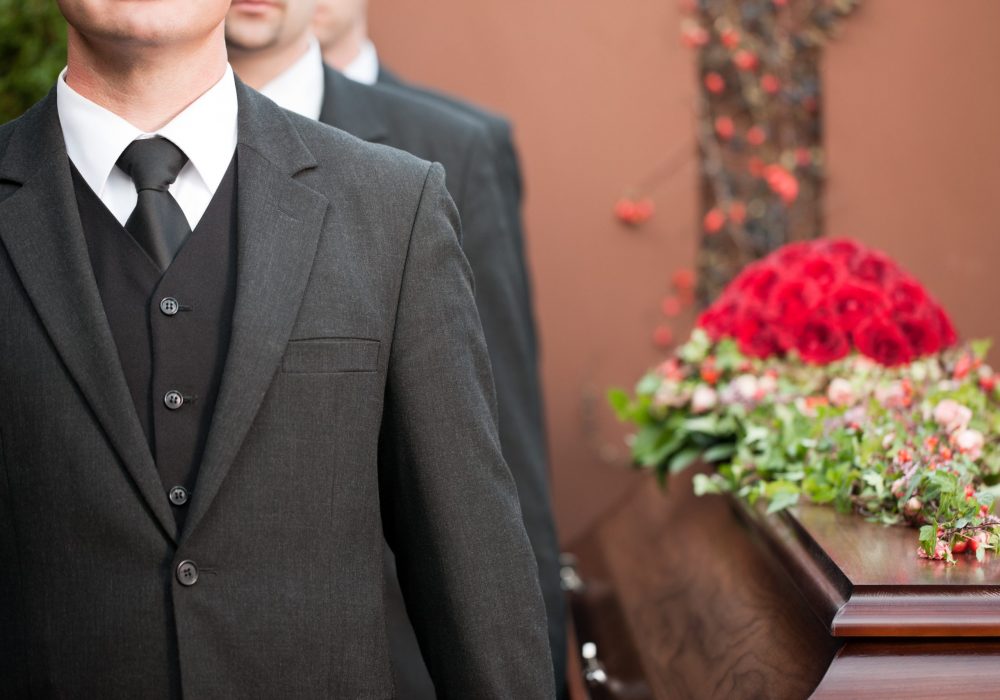 coffin bearer carrying casket at funeral Religion, death and dolor - coffin bearer carrying casket at funeral to cemetery