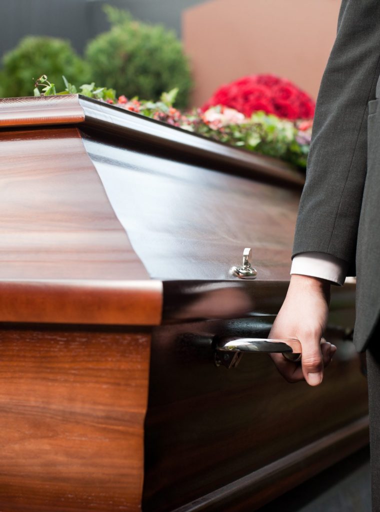 coffin bearer carrying casket at funeral Religion, death and dolor - coffin bearer carrying casket at funeral to cemetery